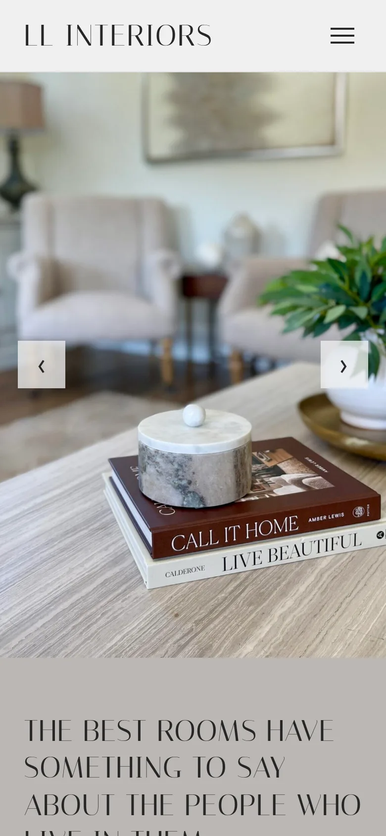The LL Interiors home page on a phone with a photo of a styled coffee table